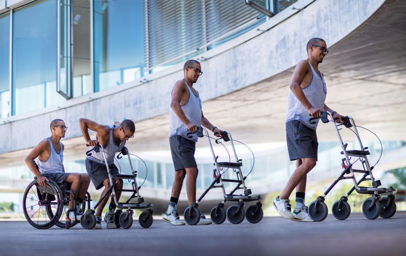 A paralyzed man walking again with the support of advanced medical treatment and assistance