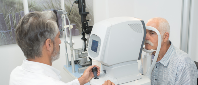 echnician using ophthalmic equipment for an eye examination